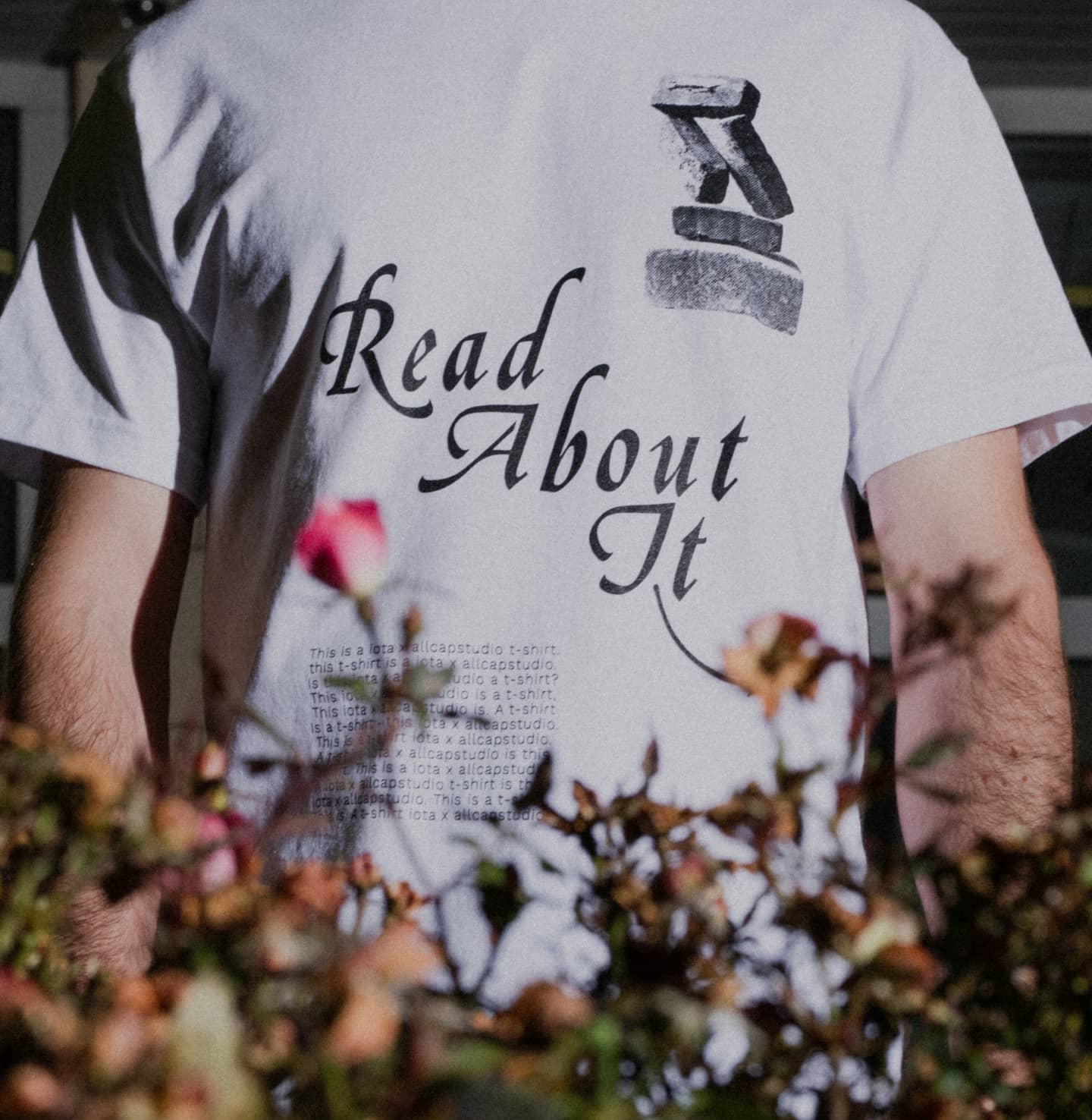 Close up of ALLCAPS x IOTA shirt front