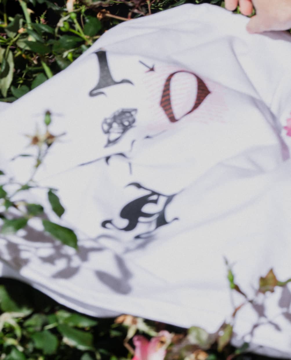 Blurry detail shot of ALLCAPS x IOTA shirt