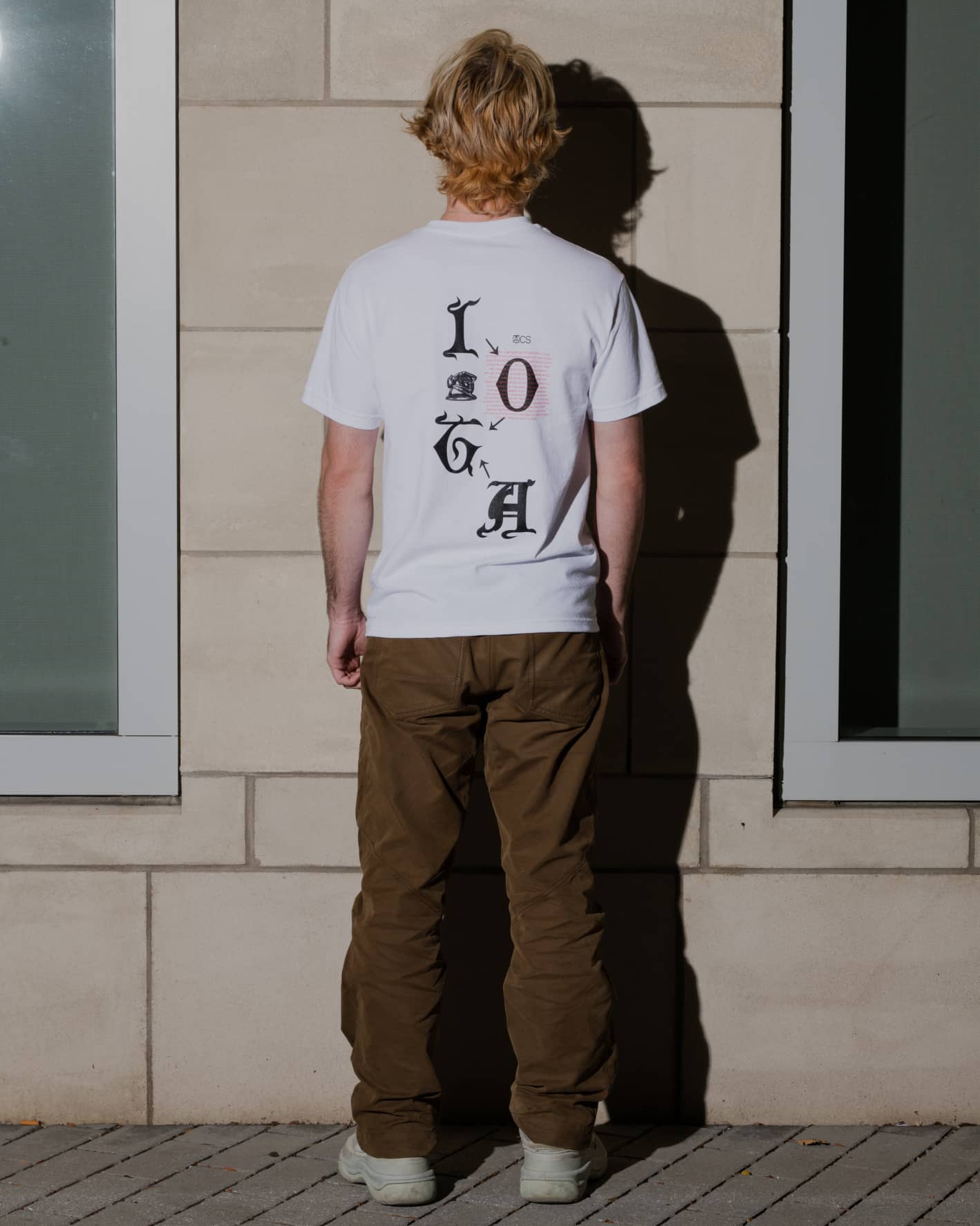 Man wearing ALLCAPS x IOTA shirt