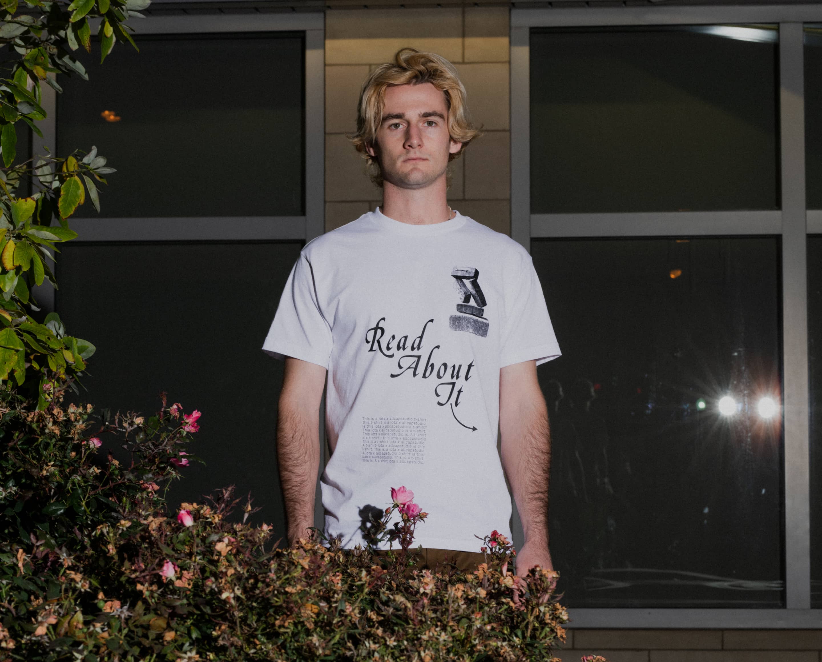 Man wearing ALLCAPS x IOTA shirt 