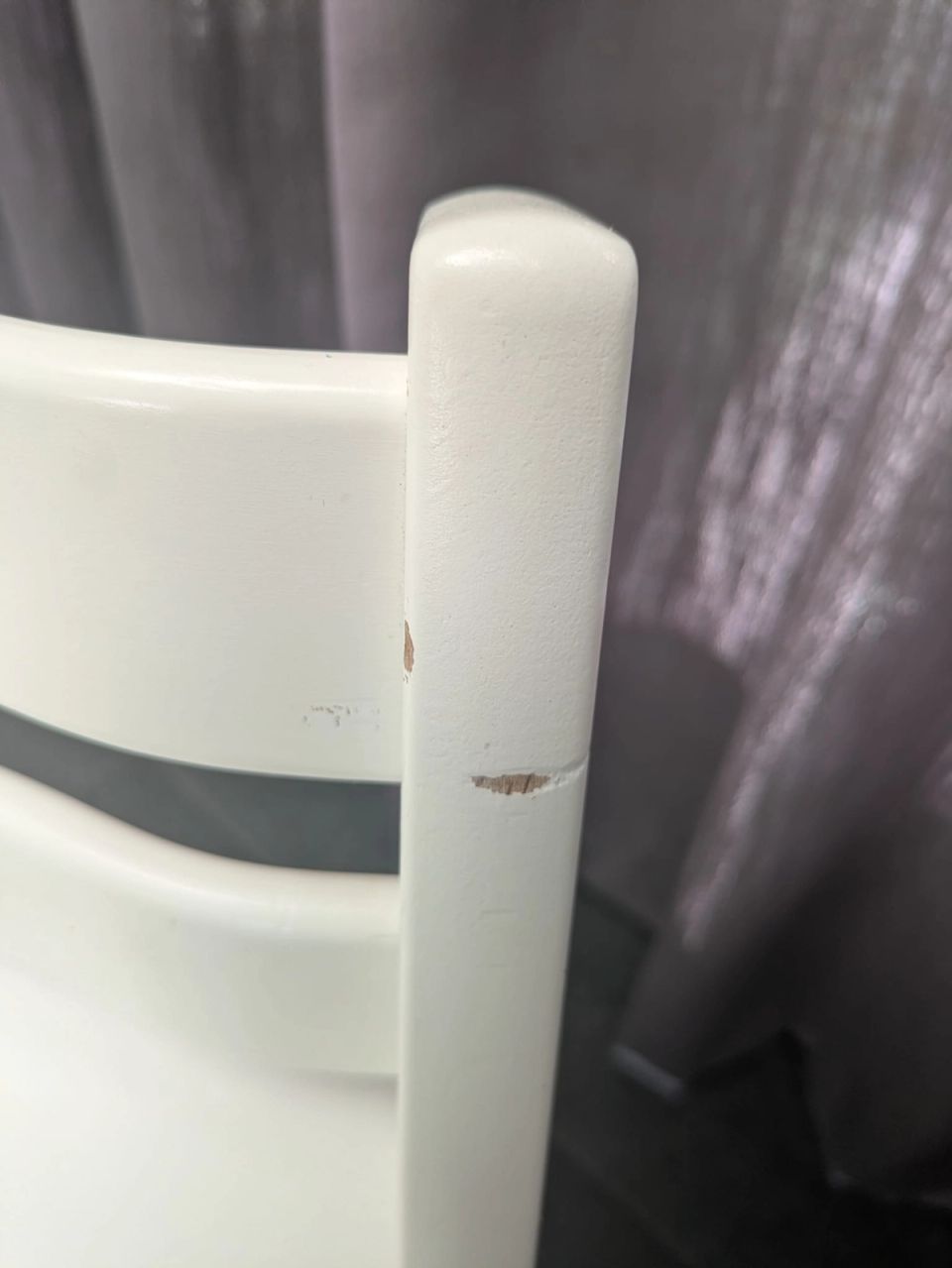 Paint damage on a white Stokke Tripp Trapp where the chair often hits the table