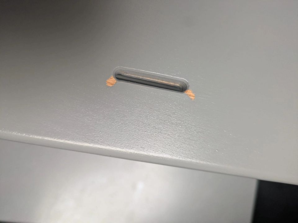 Paint damage around the cutout of the grey Stokke Tripp Trapp seat after more than five years of use