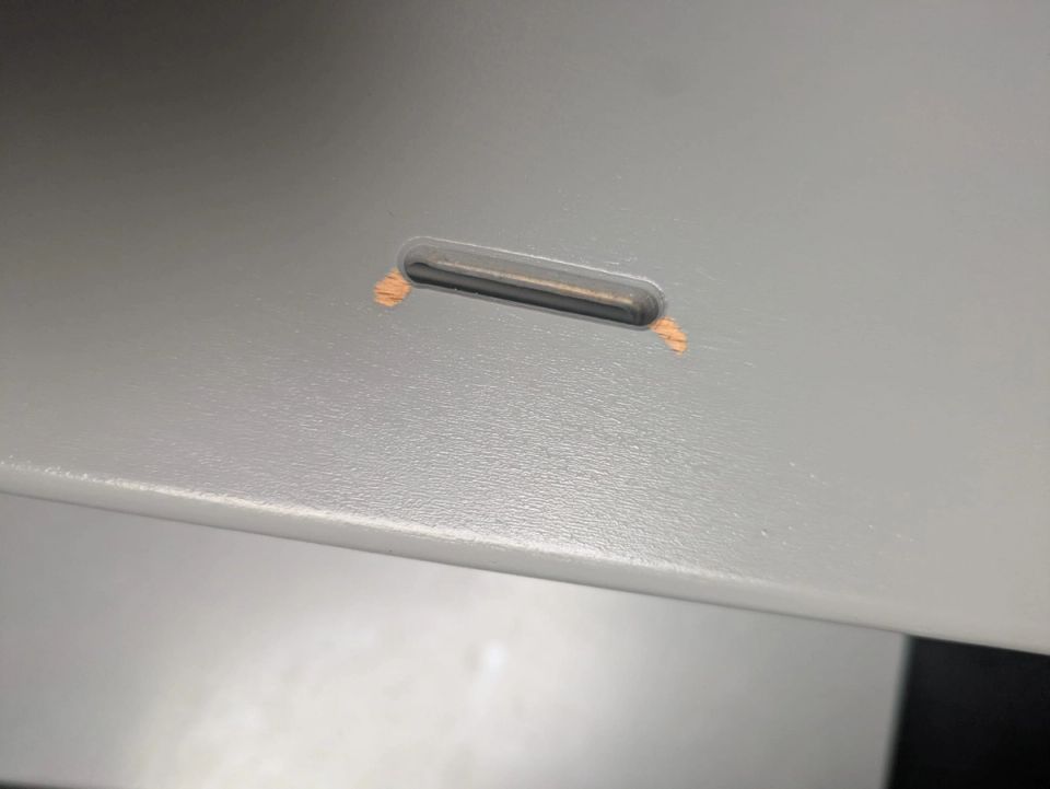 Paint damage around the cutout of the grey Stokke Tripp Trapp seat after more than five years of use