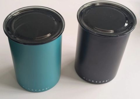 Our turquoise and black Airscape coffee canisters with their transparent outer lids closed.