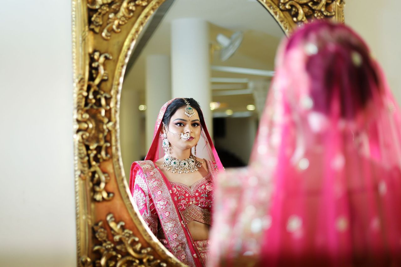 A subject reflected in a gilded mirror