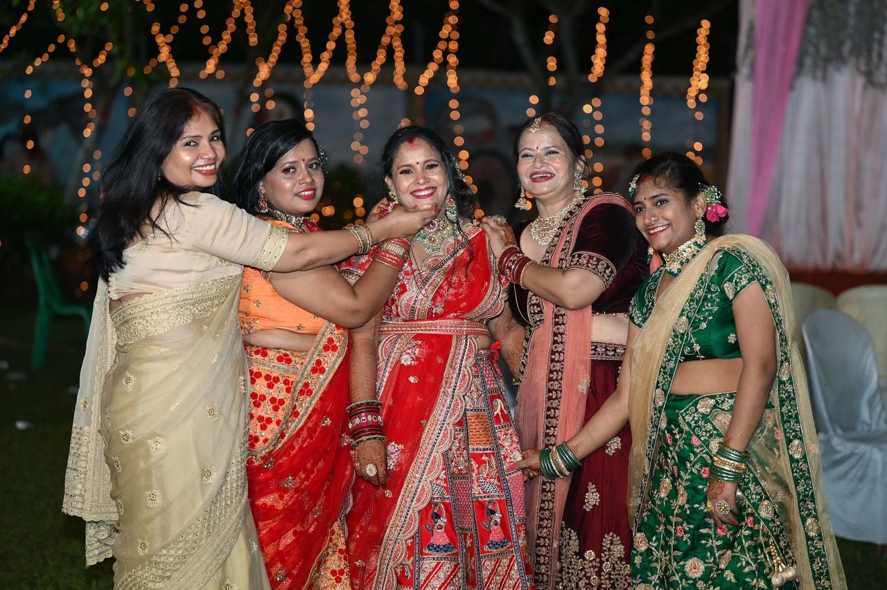 A group in traditional dress under strung lights