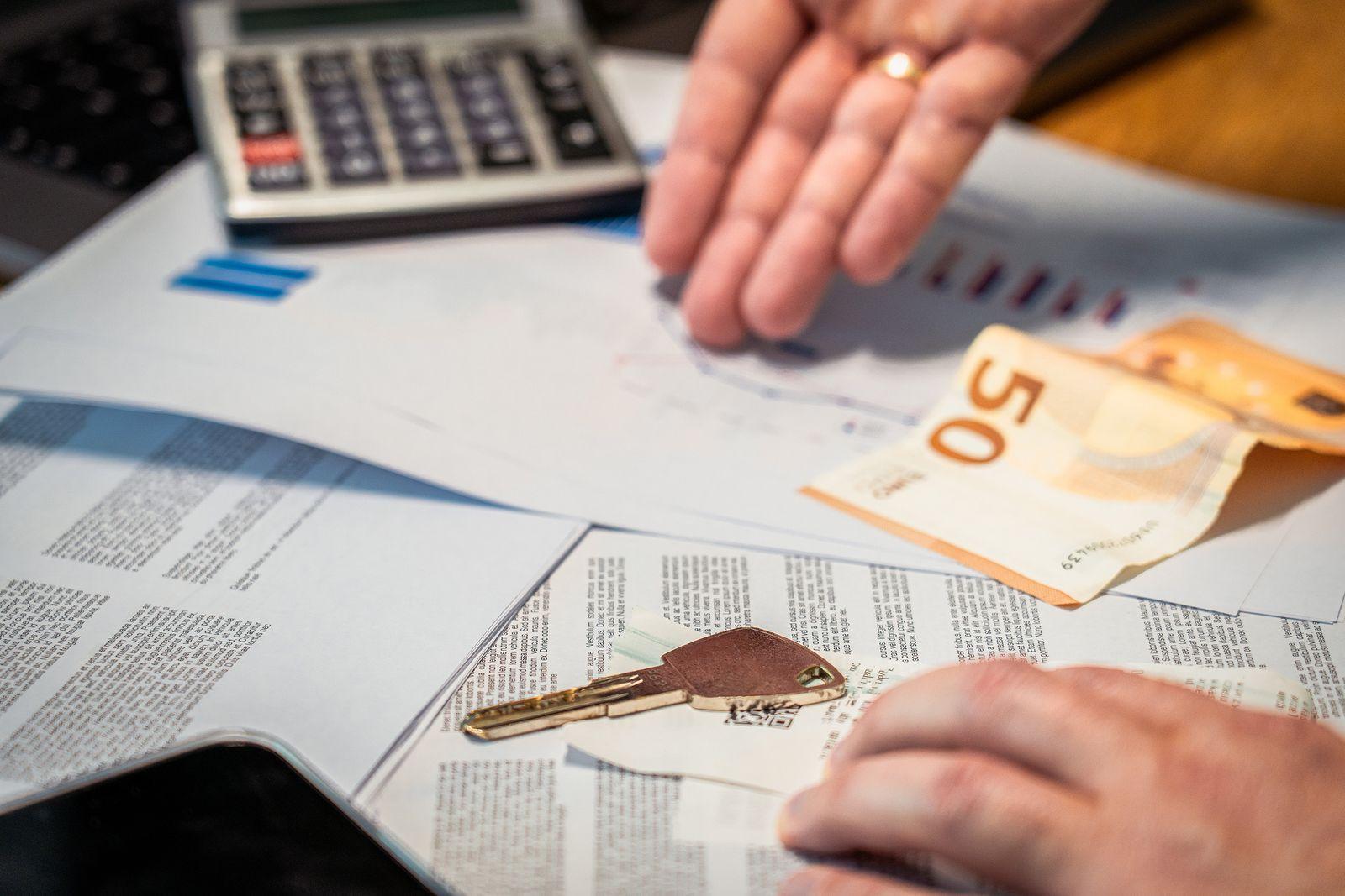 Car keys, cash and finance paperwork on a desk, illustrating BYD M9 and Kia Carnival pricing and finance