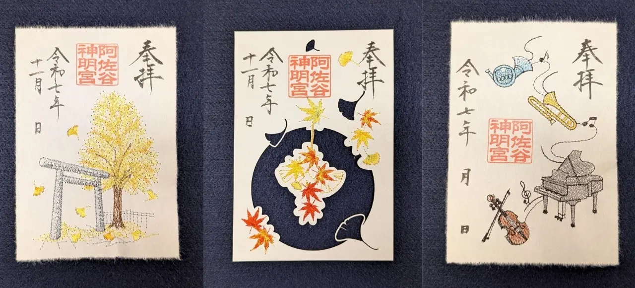 Three Japanese Goshuin: one with a torii gate and ginkgo tree, one with autumn maple and ginkgo leaves