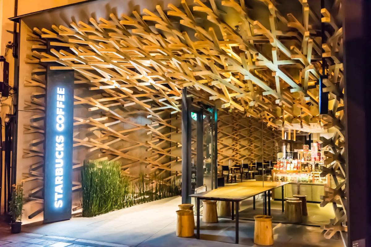 Starbucks Coffee shop with an intricate interwoven wooden design on its facade and interior.