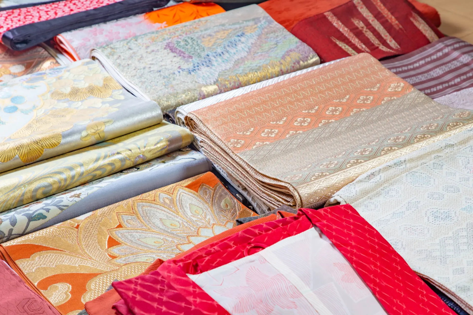 Folded silk fabrics with intricate traditional patterns.
