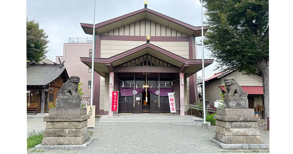A traditional Japanese shrine with two Komainu (guardian lion-dog) statues.