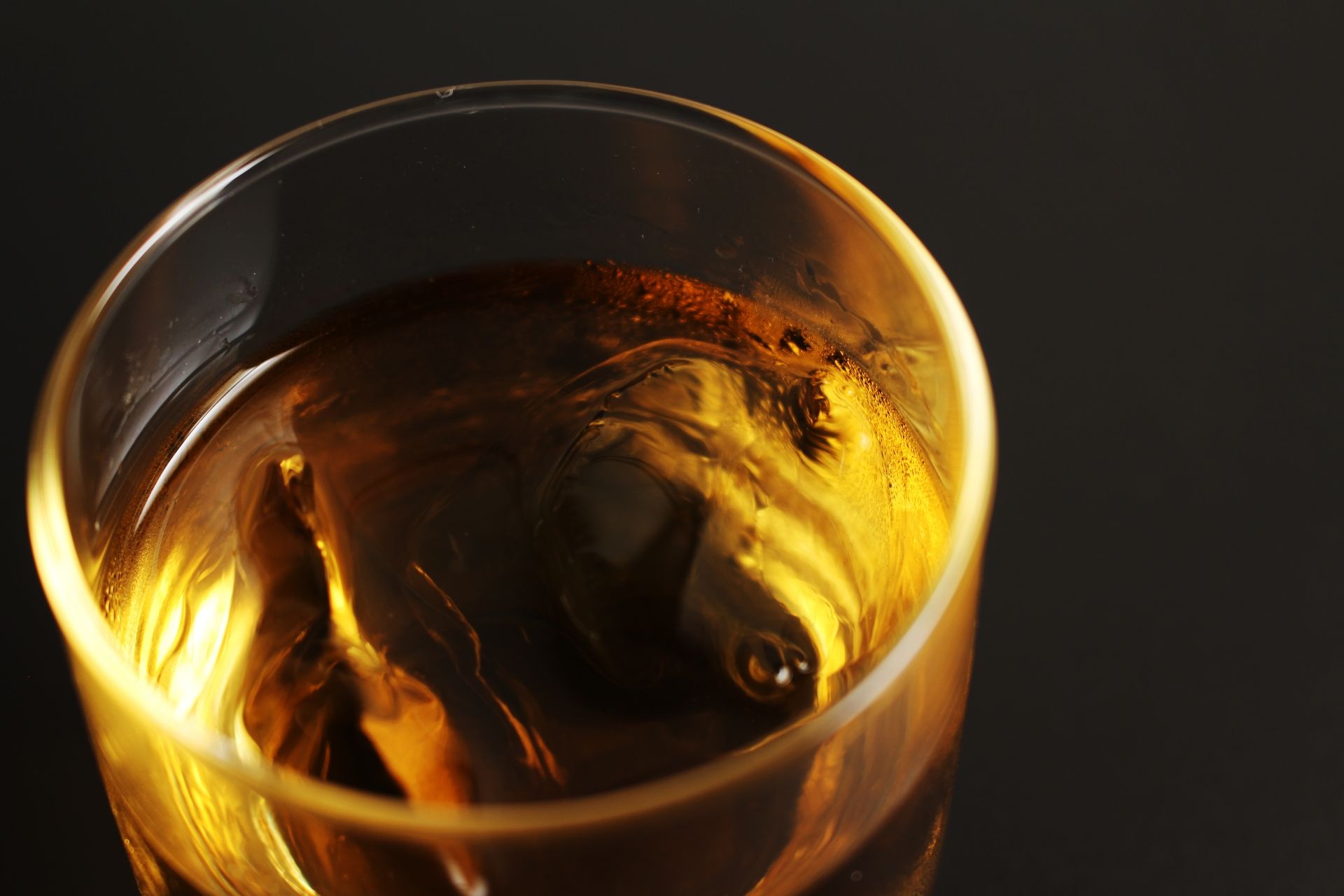 A glass of whiskey with ice.