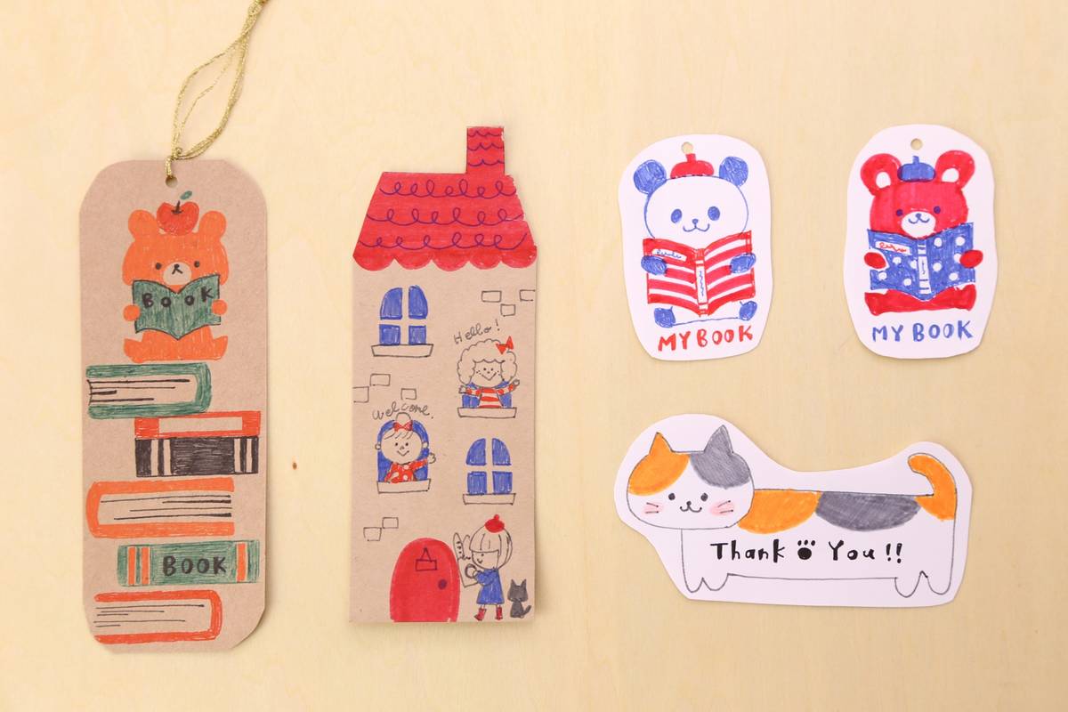 Handmade paper crafts including a bear bookmark, a house, two bear cutouts reading books
