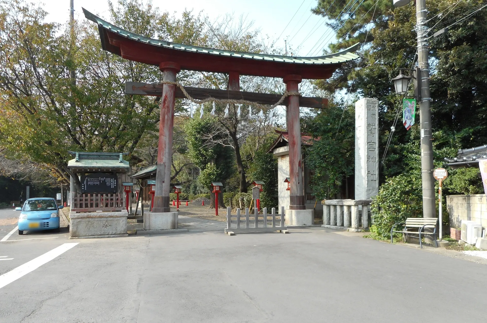 A large red torii gate marks the entrance to a Shinto shrine