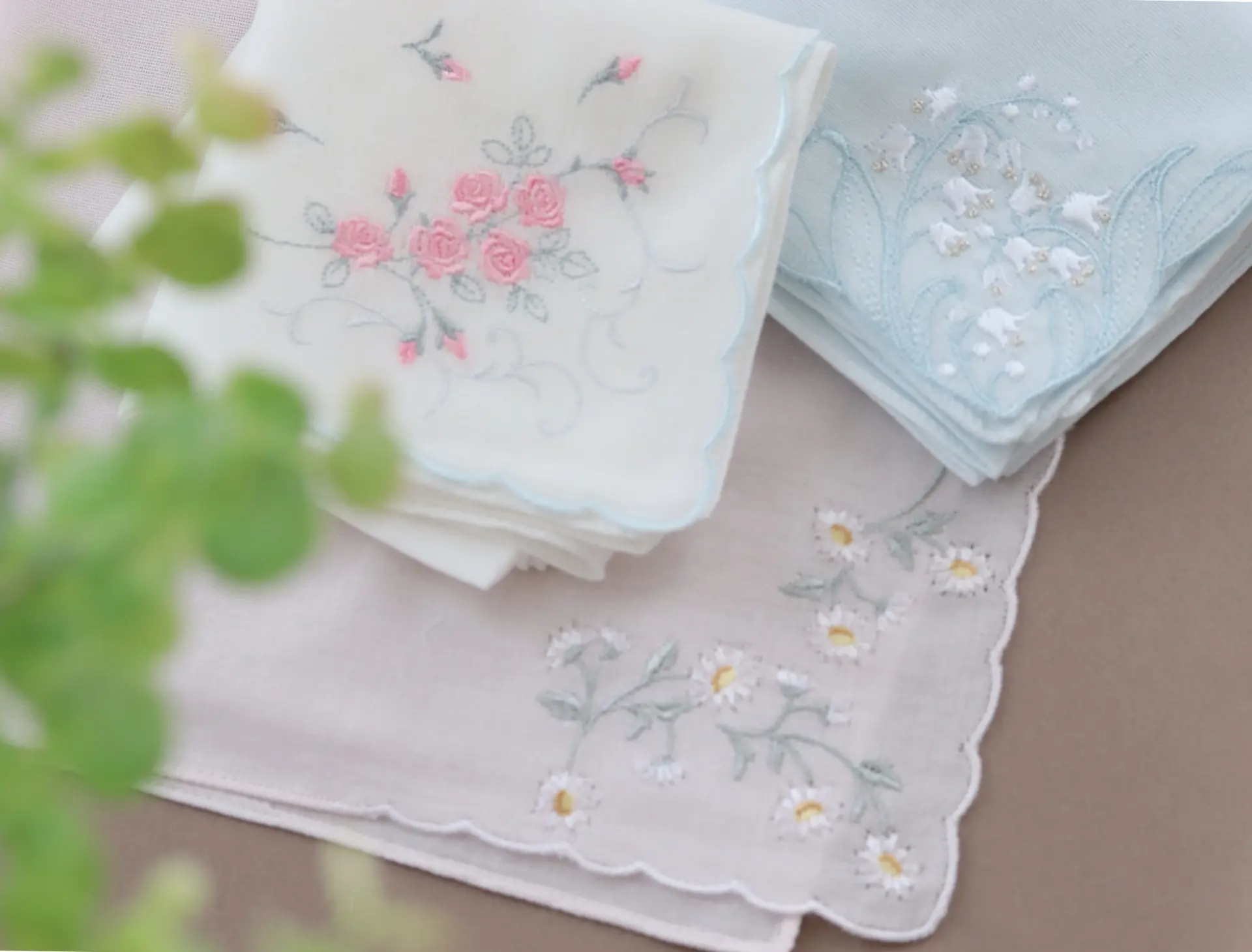 Three embroidered handkerchiefs