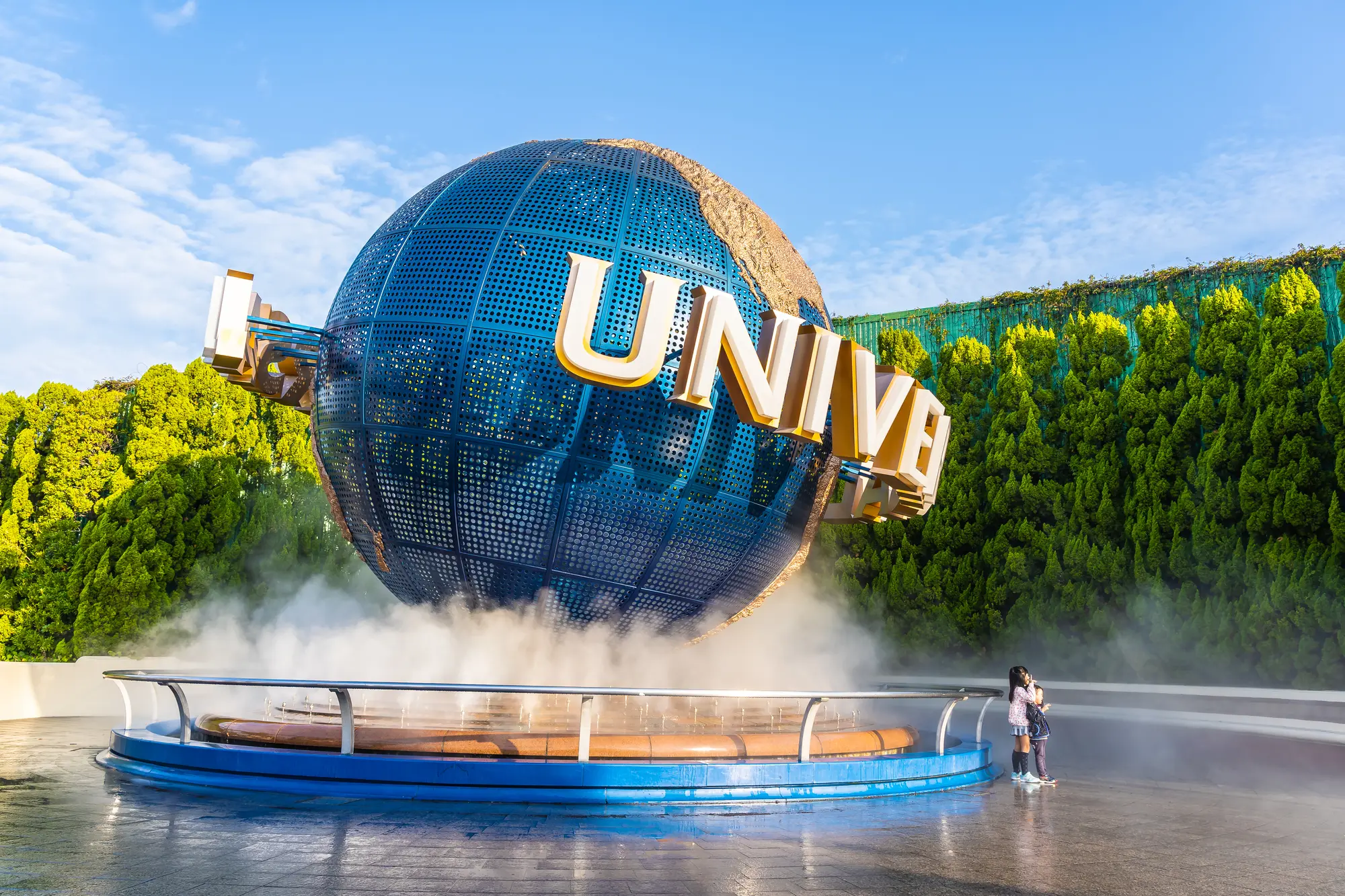 The Universal Studios globe monument with "UNIVERSAL" clearly visible, surrounded by mist.
