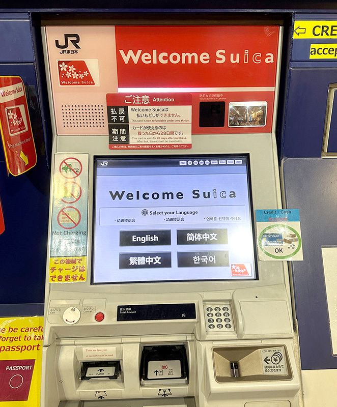 A JR East Welcome Suica vending machine with a language selection screen