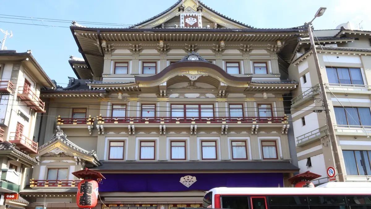 a large building with a lot of windows and a bus parked in front of it .