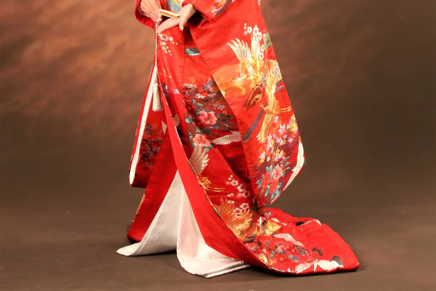 Red kimono with golden phoenixes, cranes, and floral patterns, showing a white lining.