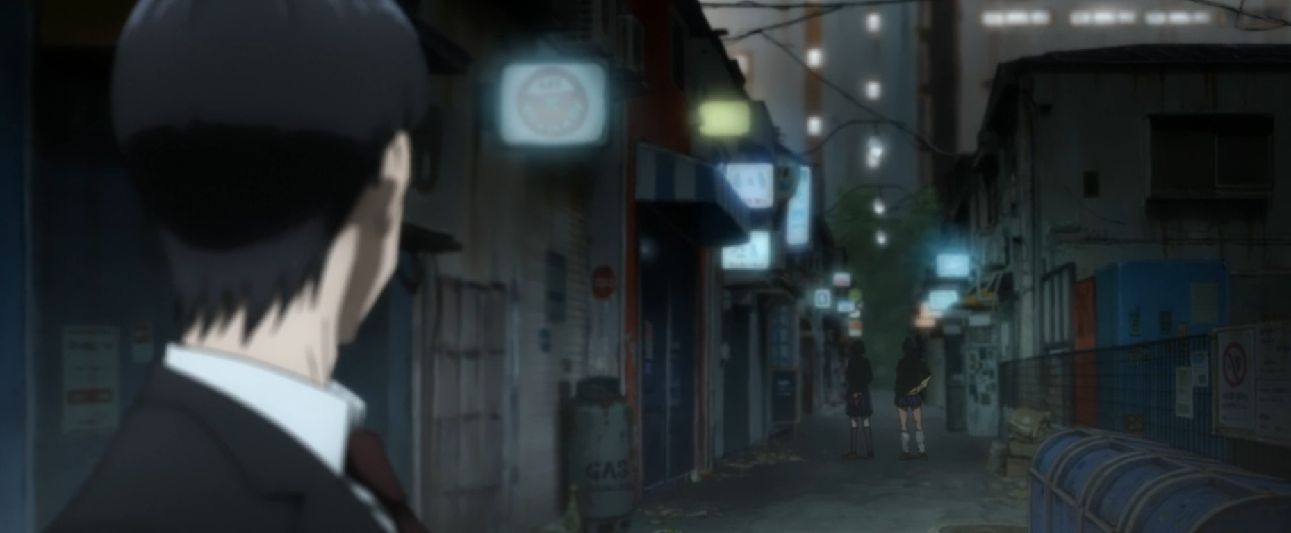 Anime: Man's back in a suit looks down a neon-lit street at two distant figures.