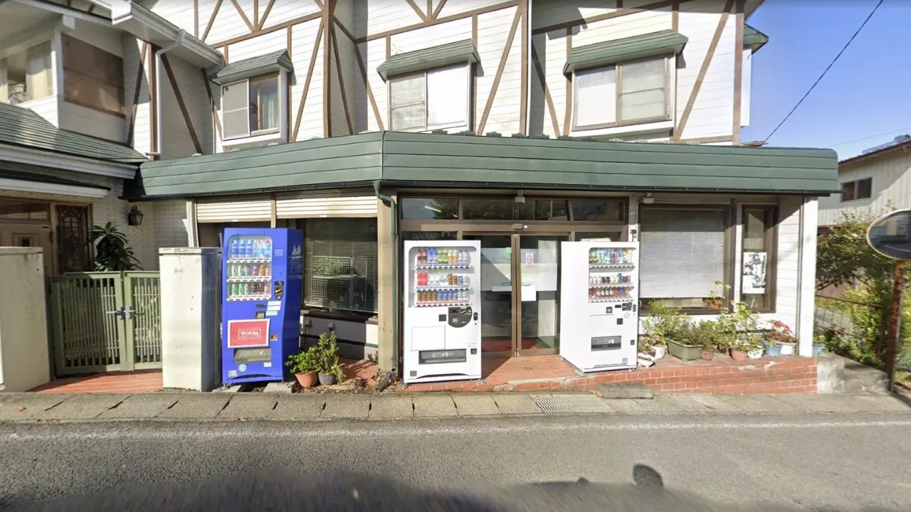 a building with two vending machines in front of it .