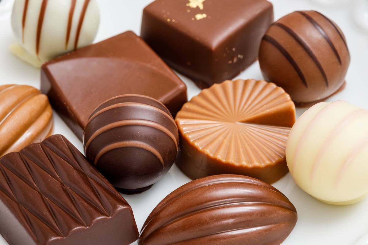 Assorted chocolates in various shapes and shades of brown and white.