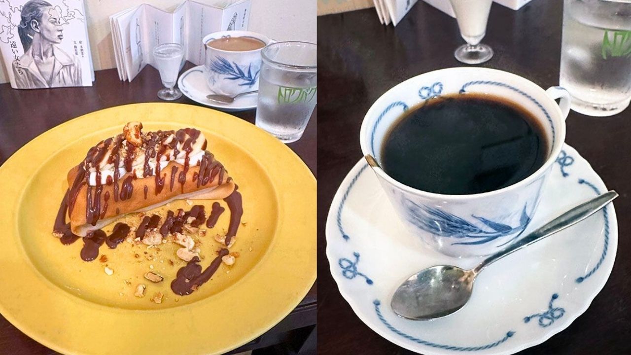 A dessert crepe with chocolate, whipped cream, and nuts on a yellow plate, next to a cup of black coffee.
