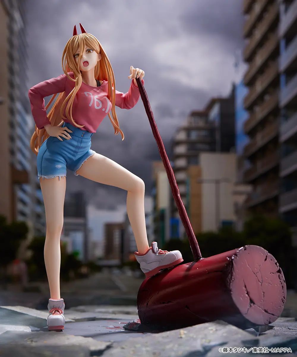 A collectible figure of Power from Chainsaw Man, dressed in a pink sweatshirt and denim shorts