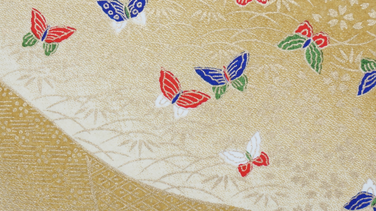 Decorative gold and cream paper with multicolored butterfly patterns.
