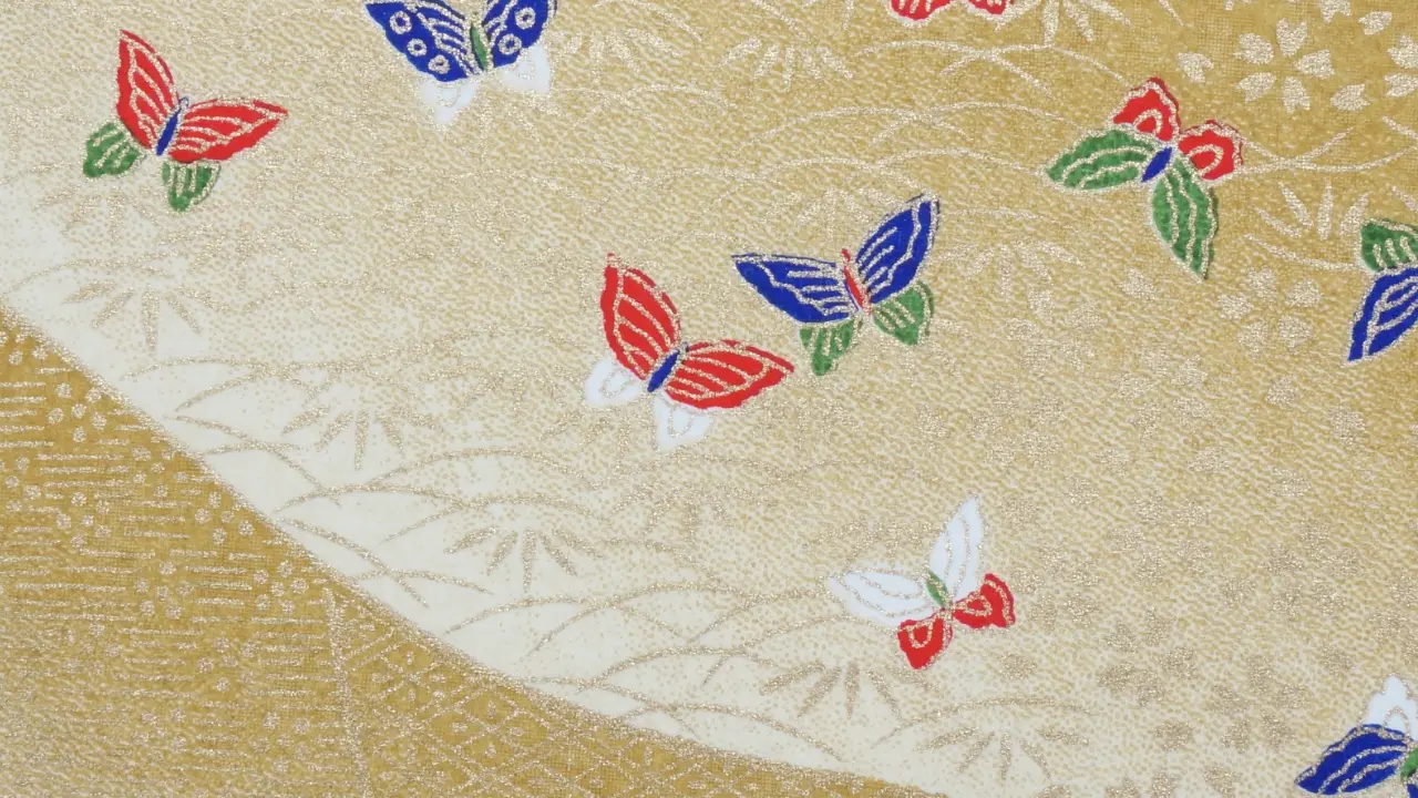 Decorative gold and cream paper with multicolored butterfly patterns.