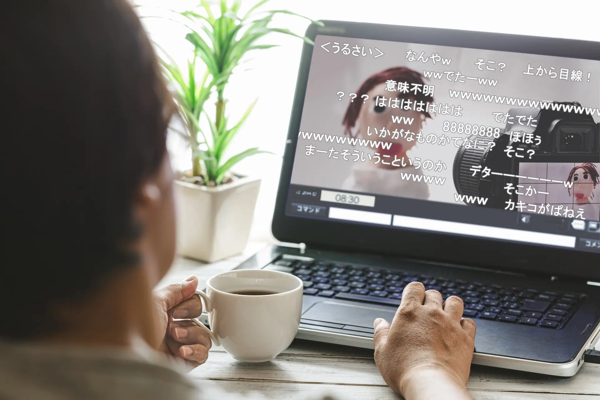 A person holding a coffee cup watches a laptop displaying a live stream with Japanese chat comments.