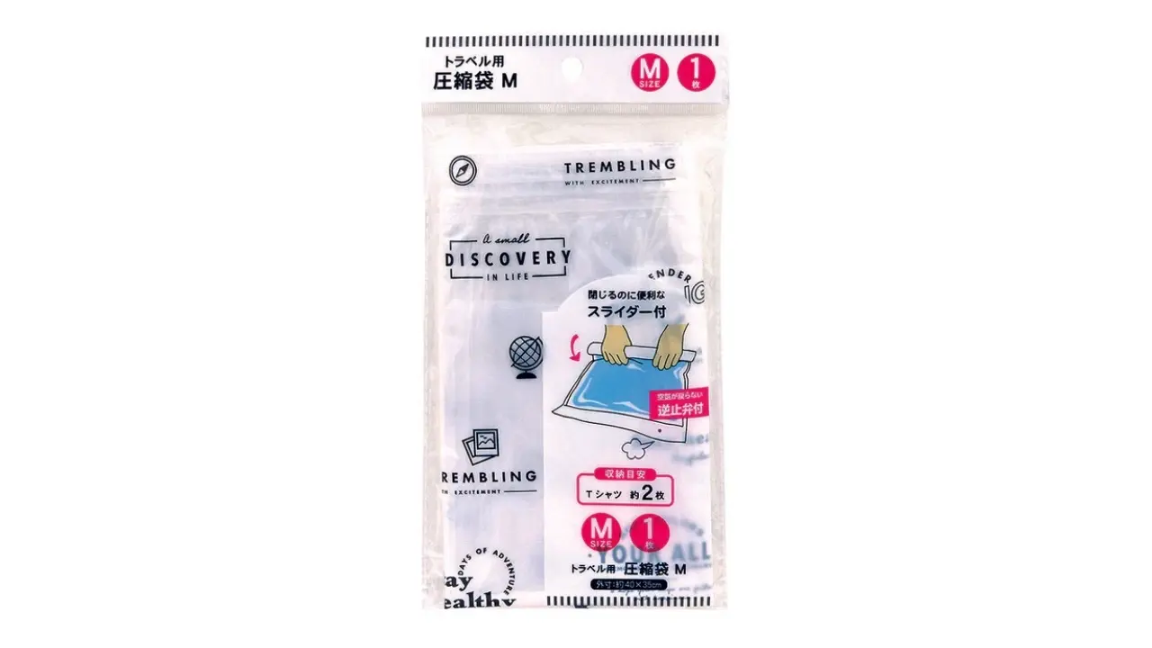 Clear plastic travel compression bag, size M, with Japanese text and instructional illustrations.