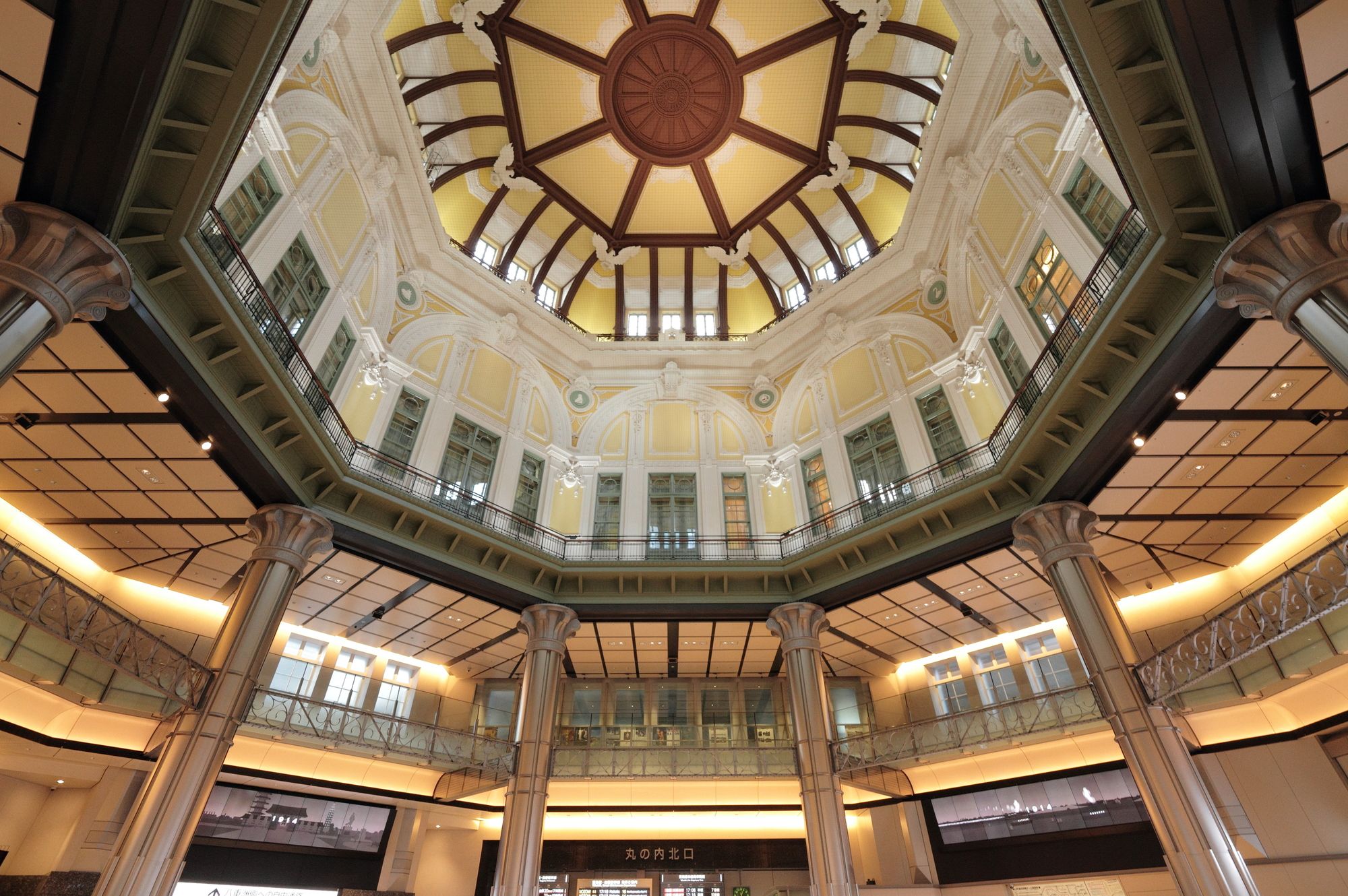 Ornate octagonal dome of Tokyo Station's Marunouchi Building, with yellow and white architectural details.