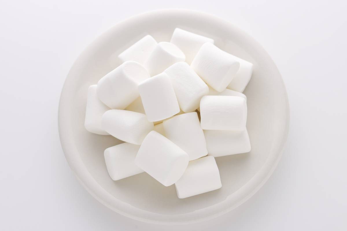 White marshmallows on a white plate.