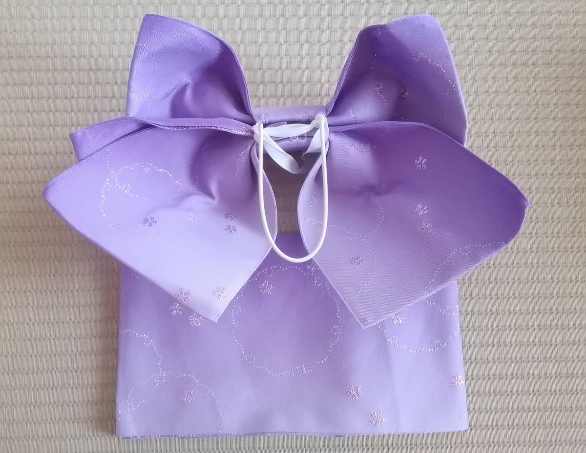 Lavender pre-tied obi with a large bow and subtle glittery floral patterns.