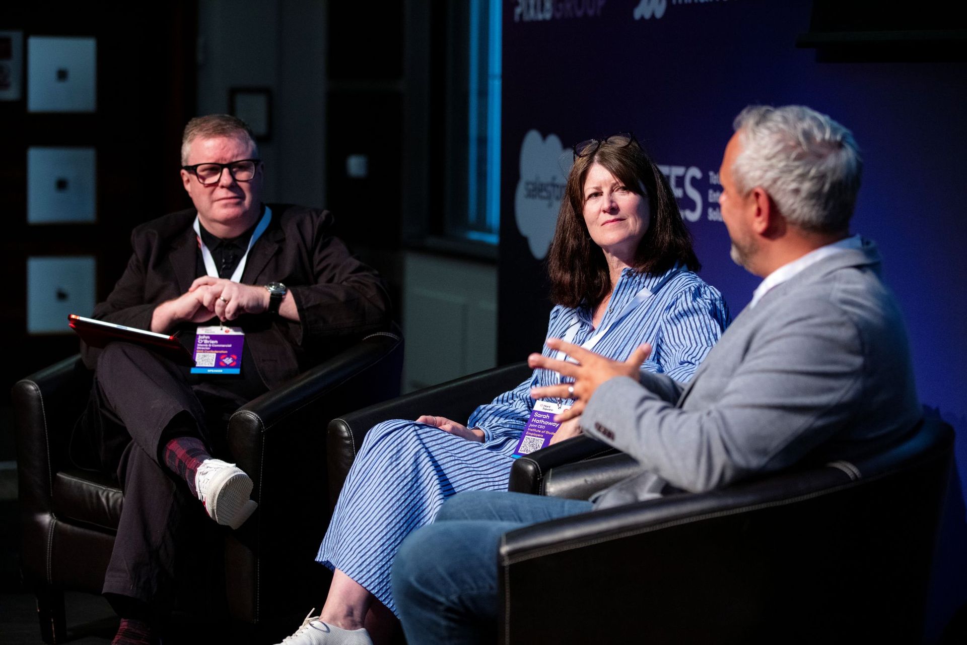 Conference chairs in discussion on stage at TechSmart