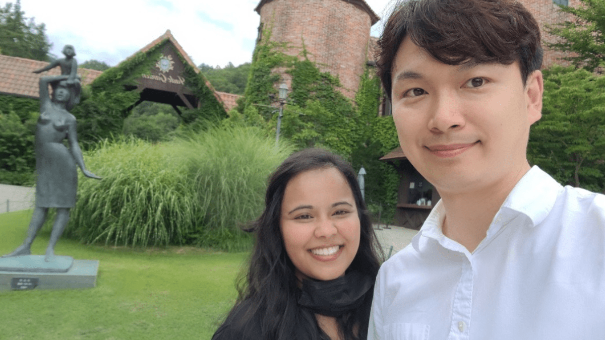 an international couple with a korean man standing in front of the jade garden to showcase unique date spots in south korea