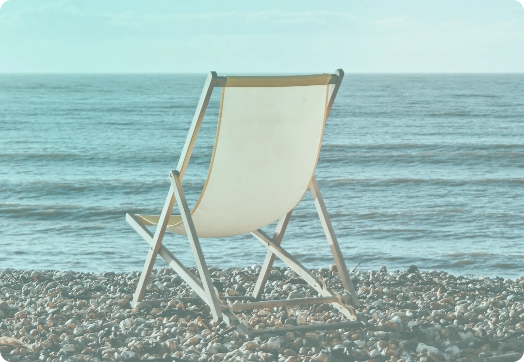 empty deck chair on beach representing retirement