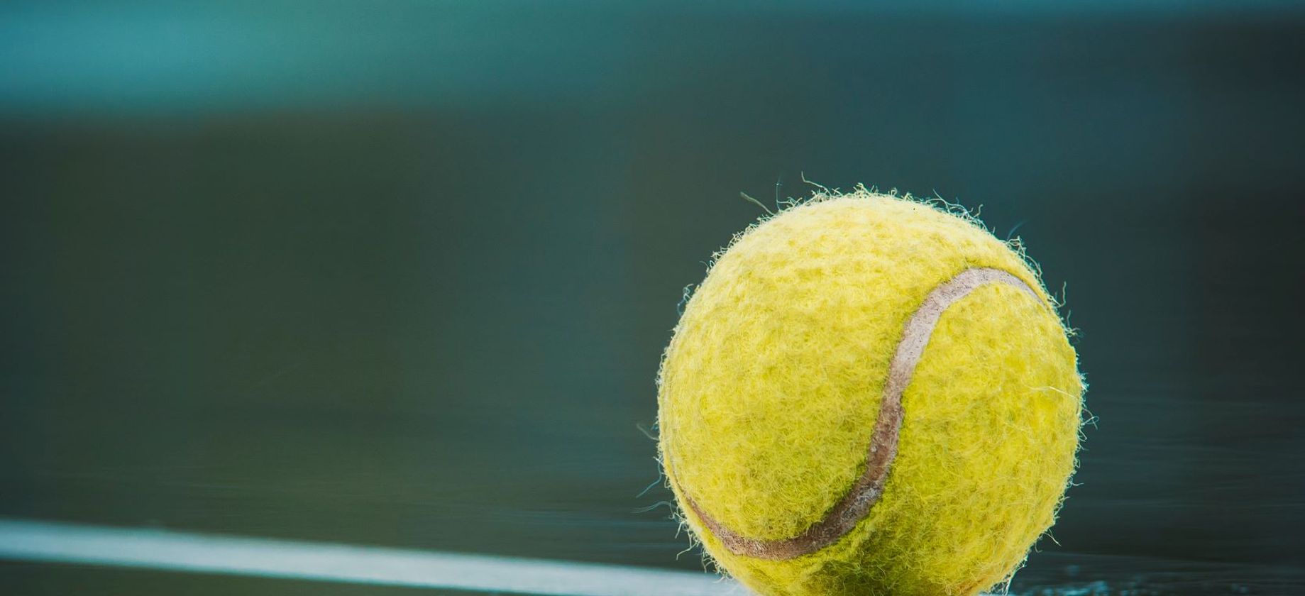 A reflection of a tennis ball on a court