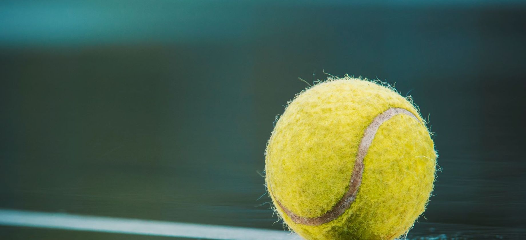 A reflection of a tennis ball on a court
