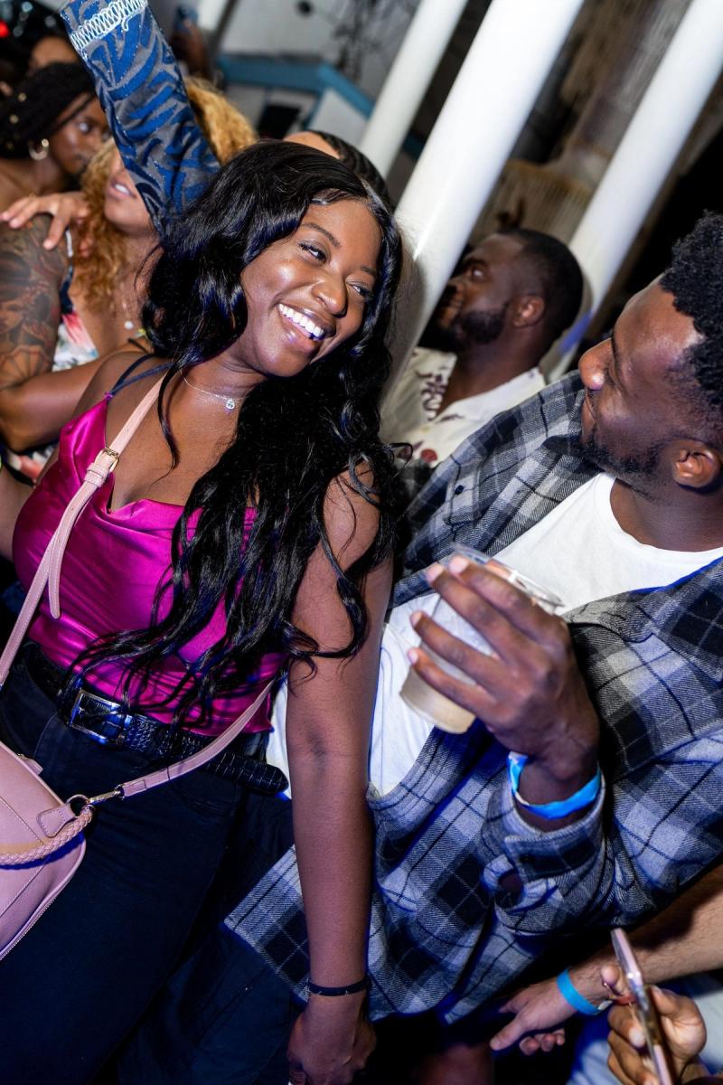 A guest smiling on a packed dance floor