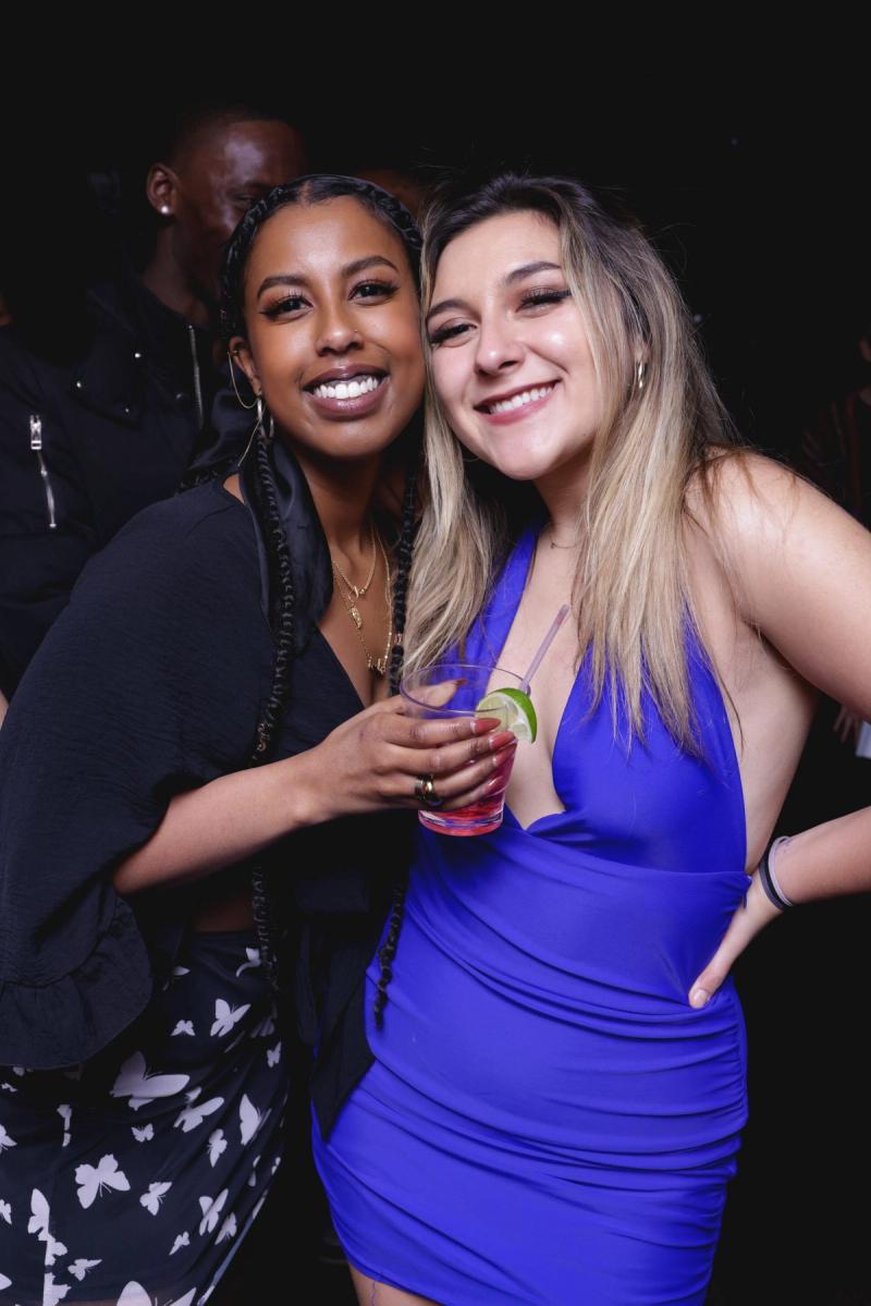 Two friends posing at the party