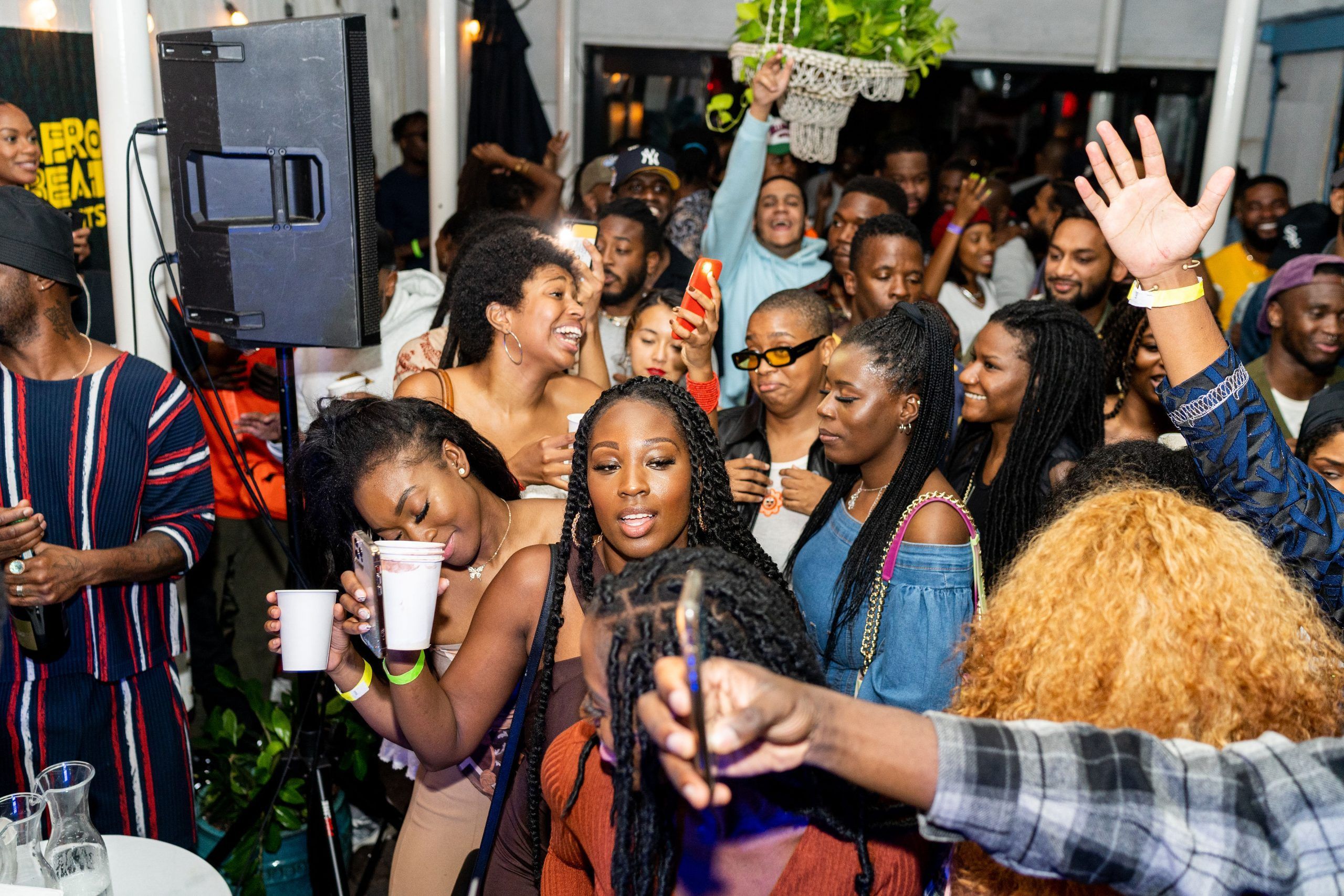 A packed crowd with drinks in hand