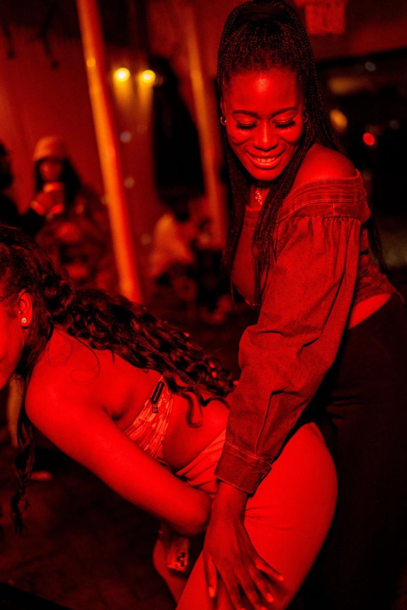 A guest dancing under red light