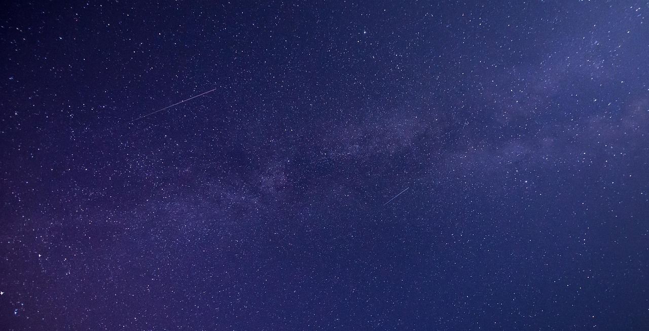 A breathtaking night sky filled with countless twinkling stars against a deep blue backdrop.