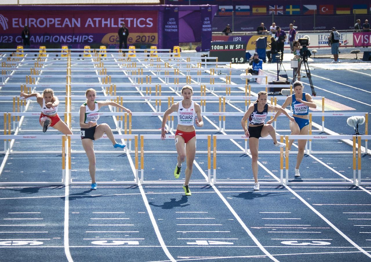 Athletes compete in a hurdle race, showcasing agility and speed. Is Steeplechase for you? Let's find out!