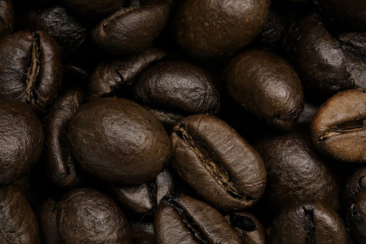 Close-up of dark roasted coffee beans, perfect for exploring 'Is Coffee Roasting for you? Let's find out!'