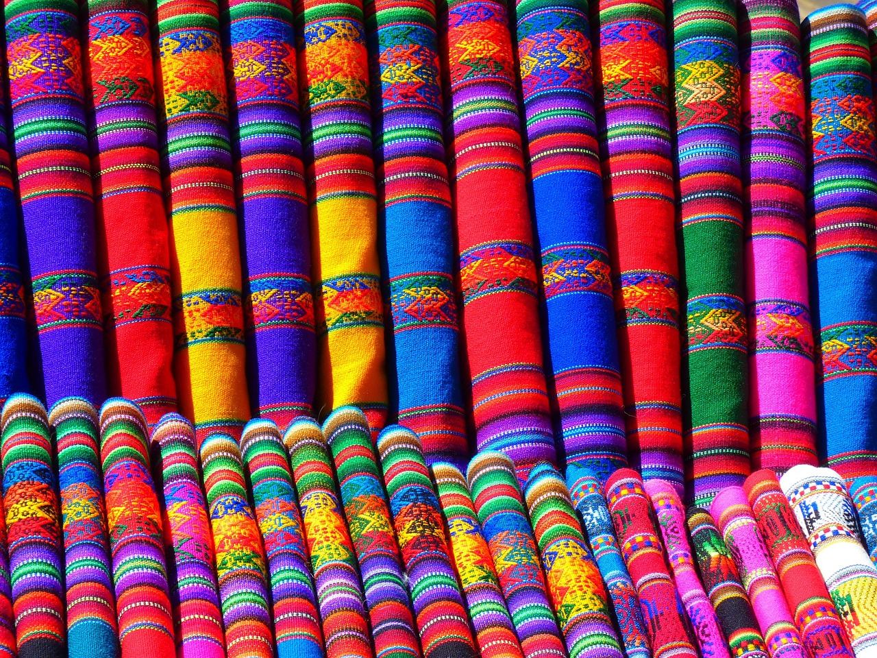 A close-up view of colorful embroidery threads neatly arranged on a vibrant fabric background, inviting creativity and craftsmanship.