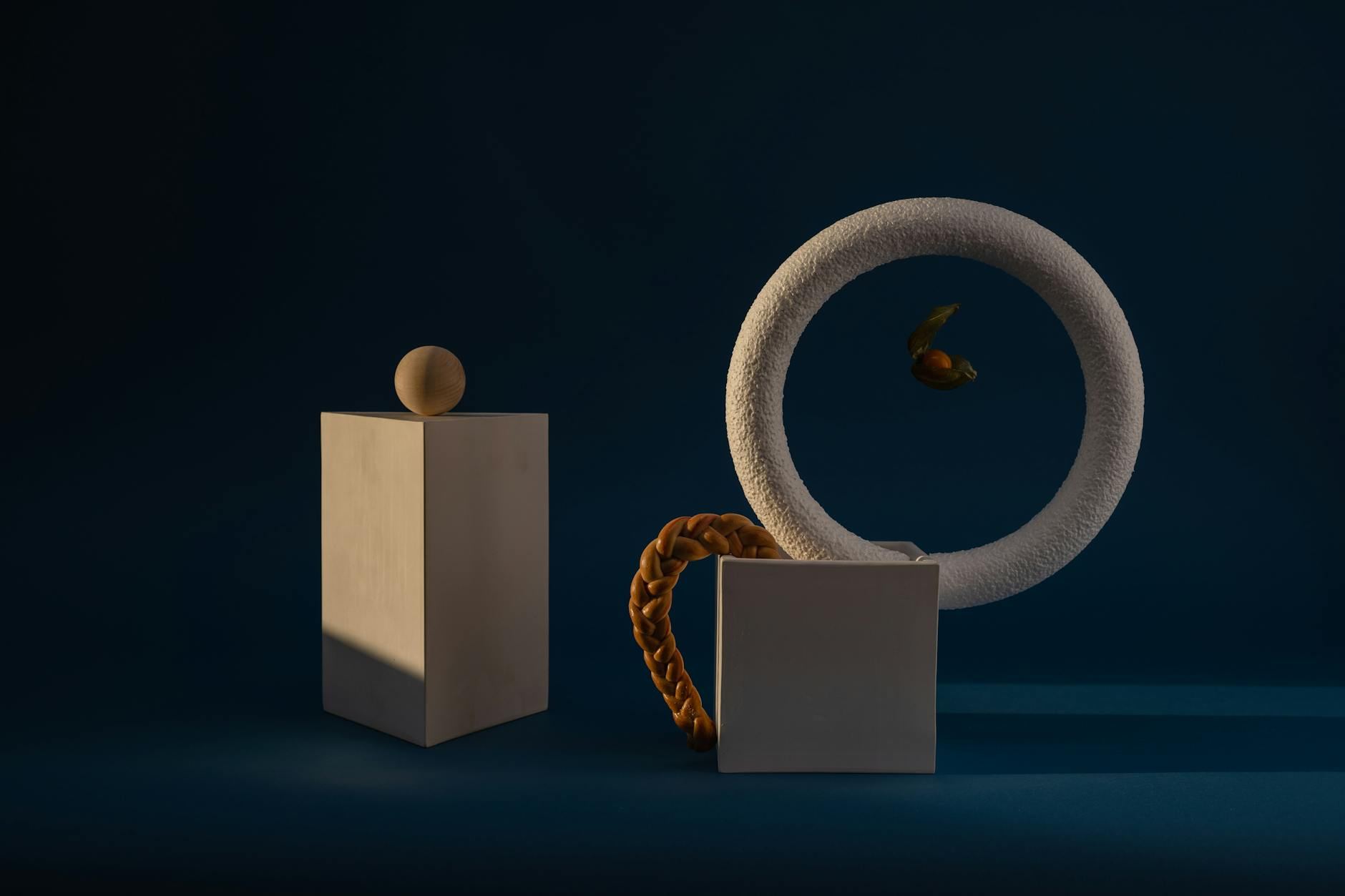 A striking minimalist installation art piece with bold geometric shapes contrasted against a deep blue backdrop.
