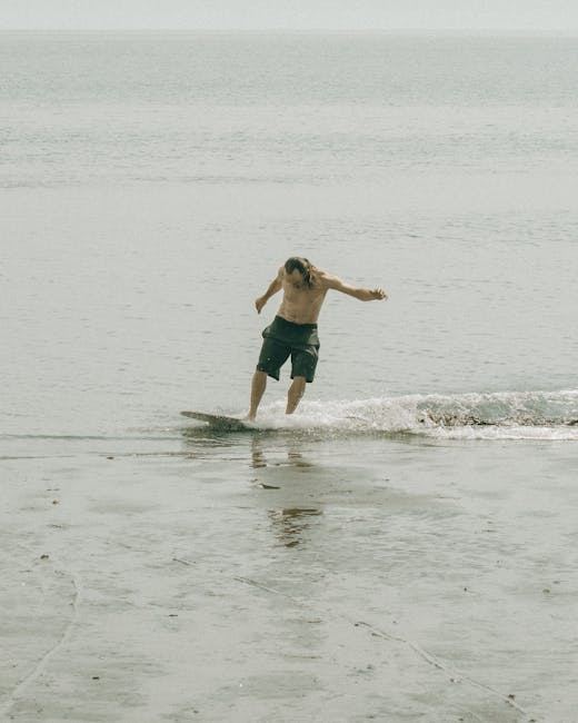 A person skimboarding on a beach, showcasing the sport's fun and dynamic nature.